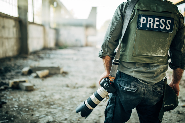 Press photographer in war zone