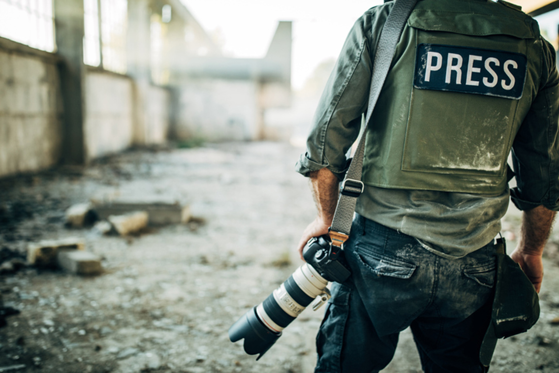 Press photographer in war zone