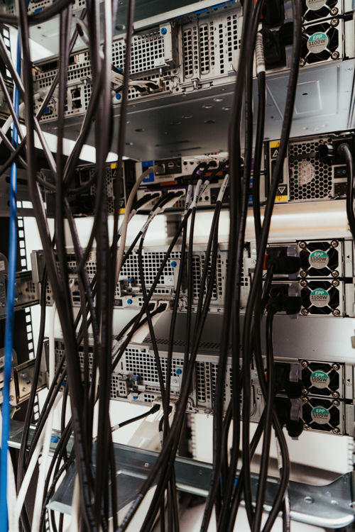 Baksiden av High Performance Computing. Store datamaskiner og mange kabler. 