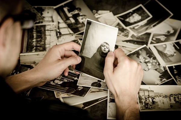 Man looking at old black and white photos