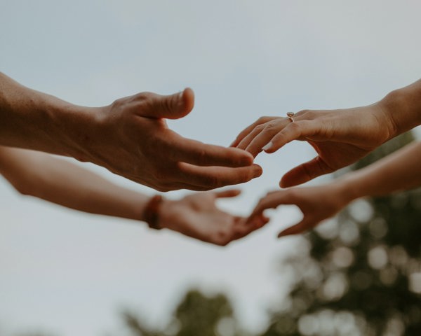 Photo of people joining hands.