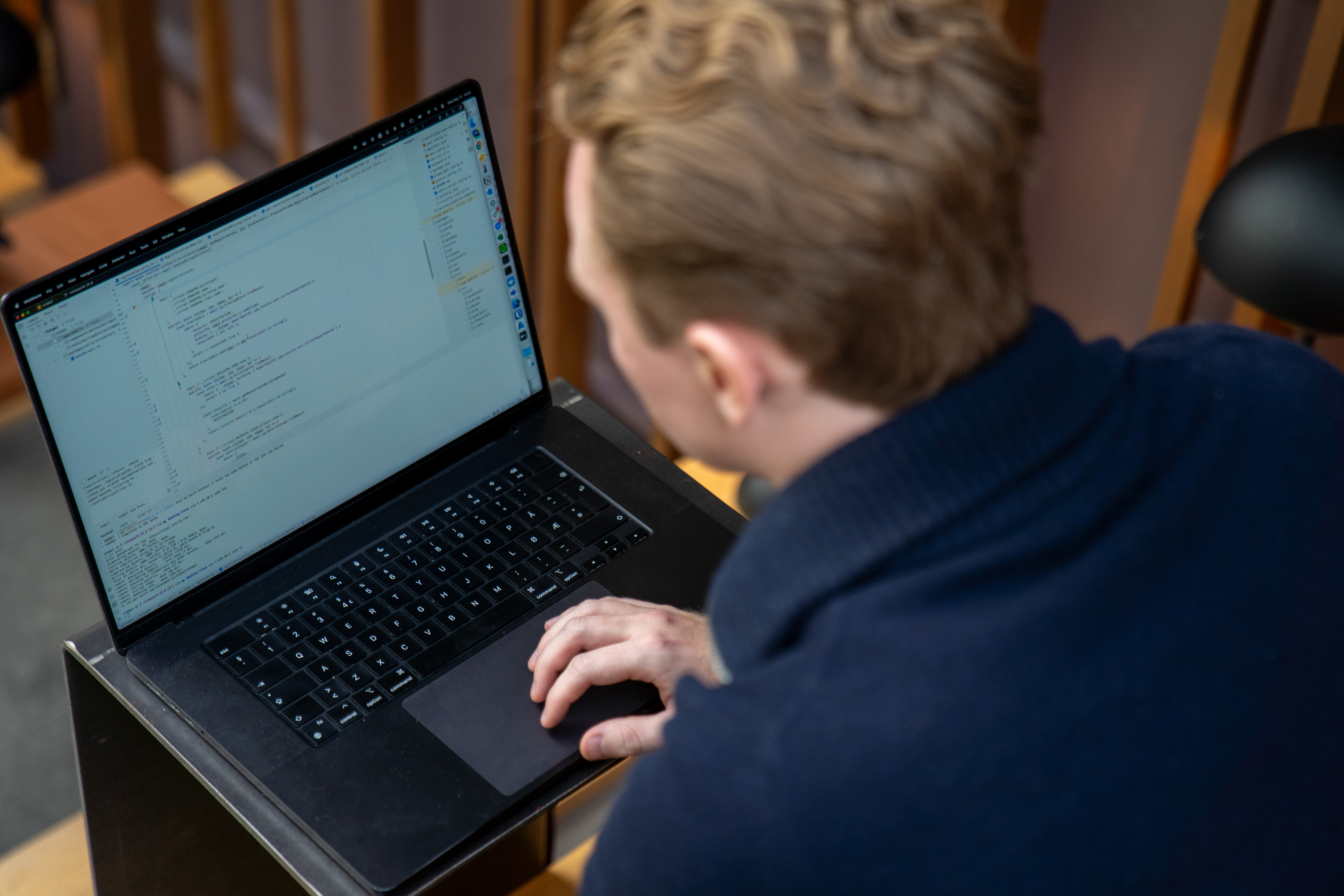 Linus som sitter å jobber med programmering, med skjermen i fokus.