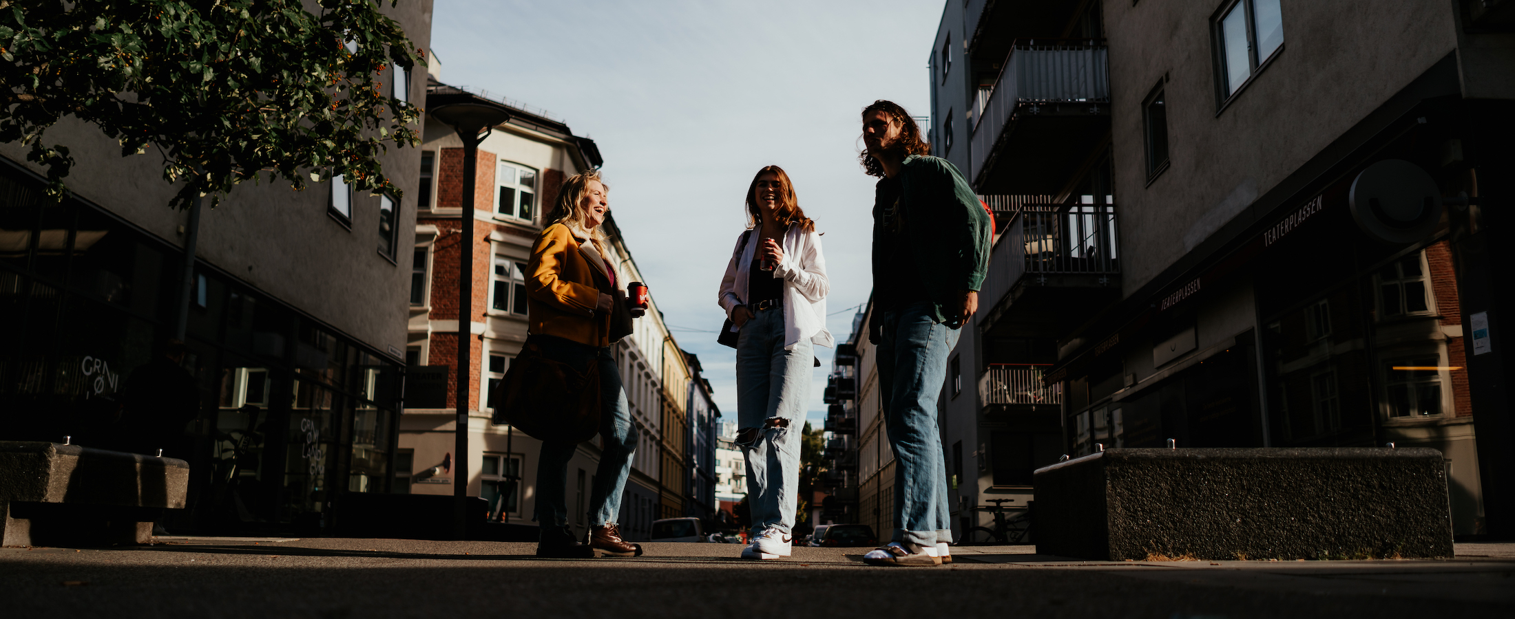 Three students chatting in a street in Oslo