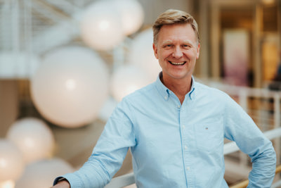 Foto av mann i dongeriskjorte oppstilt for kamera.