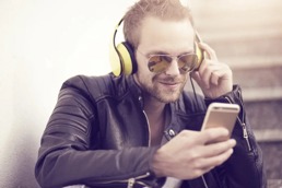 Mann som hører på musikk fra hodetelefoner.