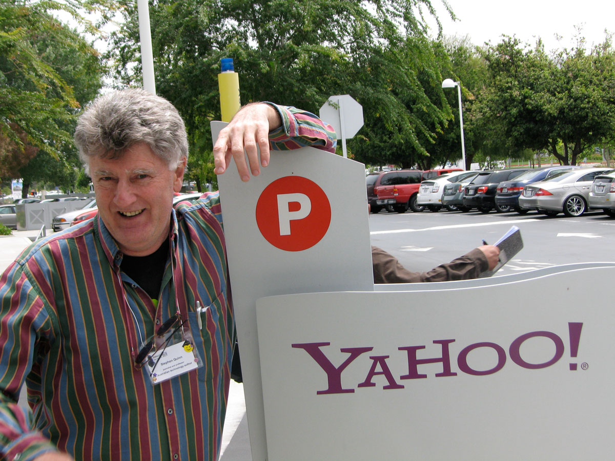 Man posing by the sign of Yahoo!
