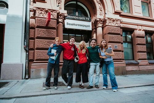 Four students standing in the streets outside campus