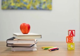 Books with apple on a table