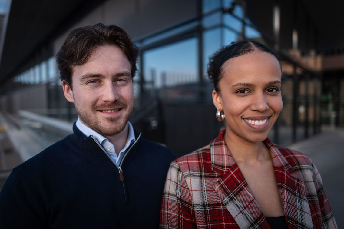 David og Amanda står foran et glassbygg.