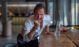 Petter Stordalen som knytter neven og smiler stort mens han ser inn i kamera