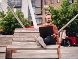 Nettstudent som studerer ute med bærbar laptop