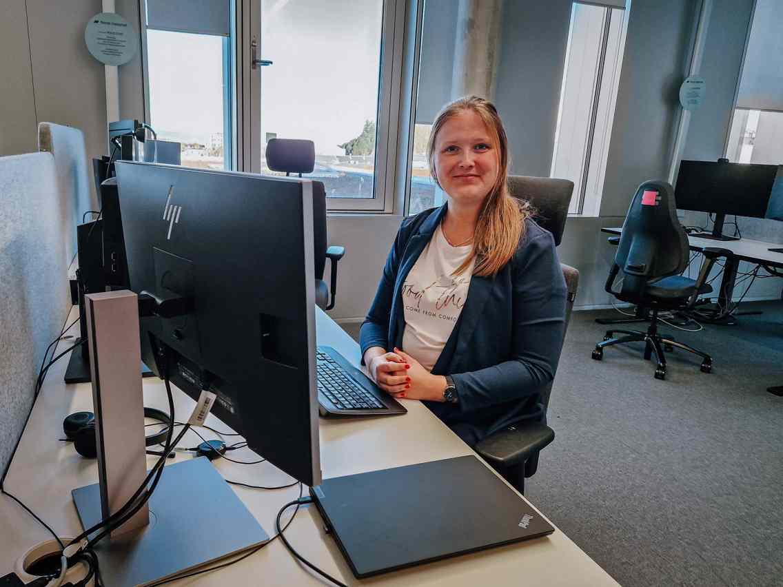 Mari sittende foran pulten sin på kontoret til Norsk Helsenett