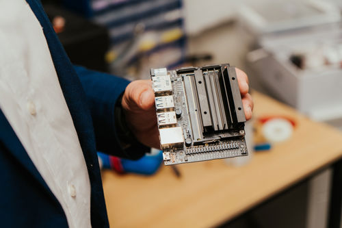 Professor Andrii Shalaginov is holding a Raspberry Pi computer